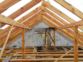 Wall Mural - Unfinished attic house roofing construction trusses, wooden beams, eaves, timber.  House roof wooden frame construction.