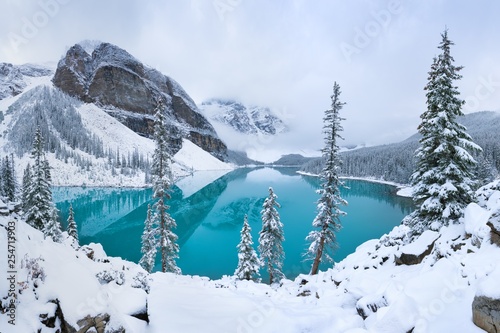 Obraz w ramie First snow Morning at Moraine Lake in Banff National Park Alberta Canada Snow-covered winter mountain lake in a winter atmosphere. Beautiful background photo