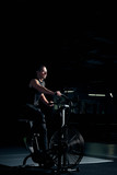 Male using air bike for cardio workout at cross training gym.