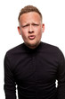 © nazarovsergey - Close up portrait of a confident, blond, handsome young man wearing black shirt, isolated on white background