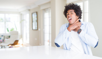 Canvas Print - African American man at home shouting and suffocate because painful strangle. Health problem. Asphyxiate and suicide concept.