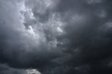 Wall Mural - Dark, grim, stormy, rainy sky with rays of light. Scary hurricane clouds. Natural element. Stock Photo for your design
