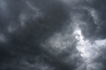 Wall Mural - Dark, grim, stormy, rainy sky with rays of light. Scary hurricane clouds. Natural element. Stock Photo for your design