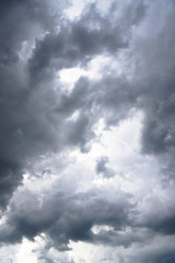 Wall Mural - Dark, grim, stormy, rainy sky with rays of light. Scary hurricane clouds. Natural element. Stock Photo for your design