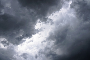 Wall Mural - dark, grim, stormy, rainy sky with rays of light. scary hurricane clouds. natural element. stock pho