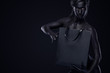 Black friday sale concept. Shopping woman with bodyart and face art holding bag isolated on dark background in holiday.