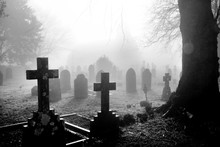 Black And White Photograph Of An English Grave Yard Covered In Thick Fog