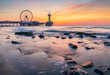 Colorful sunset on coastline, beach, pier and ferries wheel, Scheveningen, the Hague.