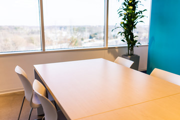 Wall Mural - New modern office table in building with wooden meeting corporate business closeup by glass window and many chairs empty nobody