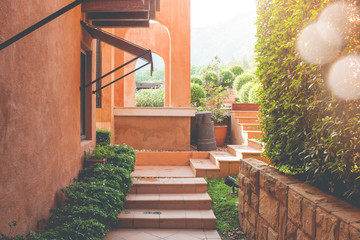 Wall Mural - Brown brick of footpath or pathway lead to outdoor garden with sunlight flare in the background.