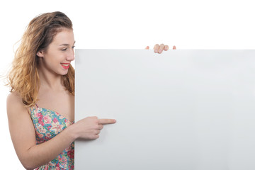 Wall Mural - happy smiling young woman showing empty blank signboard with copyspace