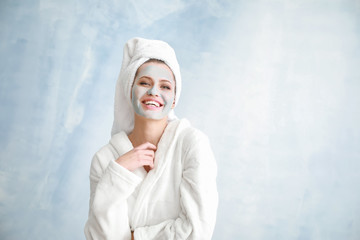 Sticker - Beautiful young woman with facial mask on light background