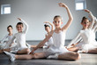 © NDABCREATIVITY - Group of little ballerinas girls doing exercises in dance school