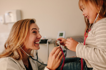 Wall Mural - Pediatrician playing with her little patient