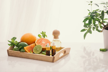 Wall Mural - organic cosmetics with herbal extracts of lemon, orange, mint on bright background