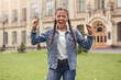 © Viktoriia - Young schoolgirl in jeans standing at school yard screaming irritated closed eyes