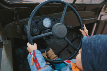 Sticker - boy holding wheel in retro car