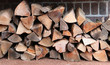 neat stack of logs against a wall