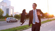 SUN FLARE: Excited yuppie dancing down the sunlit street after getting promoted.