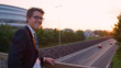 PORTRAIT: Successful yuppie turns around while watching sunset above the highway