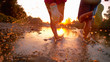 © helivideo - CLOSE UP: Glassy drops of water fly as athletic couple jogs in shallow river.