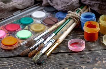 Paint brushes and paints for drawing.