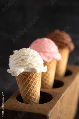 Fotomural A Line of Three Classic Flavors of Ice Cream in a Wooden Sugar Mold