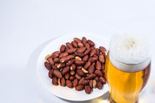 A Glass Of Beer And Peanuts In The Saucer. 