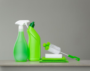 Green set of cleaning products and tools for spring cleaning.