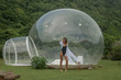 © South House Studio - pretty model in white dressing gown and black swimsuit poses near bubble tent