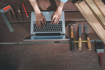 Carpenter working with equipment on wooden table in carpentry shop. woman works in a carpentry shop.