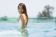 © siraphol - Beautiful young asian woman happy and smile in swimming pool for relax travel and vacation