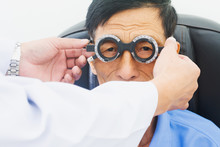 Elderly Man Having Hes Eyes Examined By An Eye Doctor On A Testing Tool In Modern Clinic, Optometry Concept