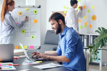 Young IT designers working in office