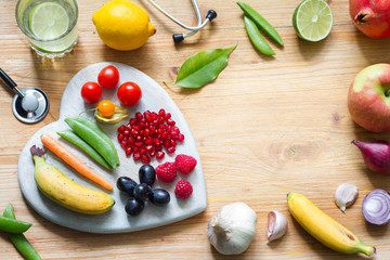 Wall Mural - Healthy lifestyle  vegetarian food in heart and  stethoscope with water alternative medicine background concept