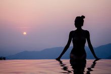 Young Woman Relaxing In Infinity Swimming Pool Looking At View Romantic Sunset Overlooking The Hills Wildernest Nature Spa Resort In India Goa Kerala