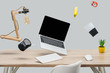 © LIGHTFIELD STUDIOS - laptop with blank screen and stationery levitating in air at workplace isolated on grey