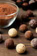 © MK studio - assorted chocolates. candy balls of different types of chocolate on a brown wooden table. close-up