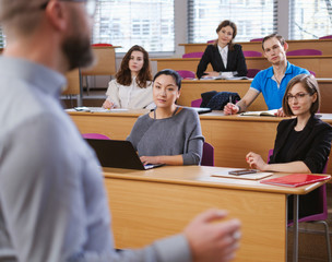 Wall Mural - Lecturer and multinational group of students in an auditorium