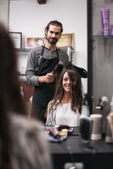 Young woman getting new hairstyle at professional hair styling saloon. 