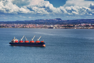 International Container Cargo ship with working crane bridge in seaport for logistic import export