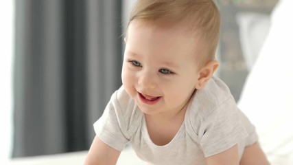 happy baby crawling on the bed