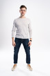 © opolja - full body picture of a smiling casual man standing on white background.