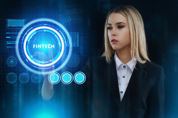 The concept of business, technology, the Internet and the network. A young entrepreneur working on a virtual screen of the future and sees the inscription: Fintech