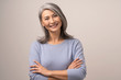 © Svyatoslav Lypynskyy - Smiling Asian senior woman with crossed arms