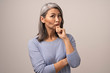 © Svyatoslav Lypynskyy - Adult Mongolian Woman with Gray Hair on a Gray Background.