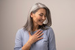 © Svyatoslav Lypynskyy - Charming Asian woman is touching her chest