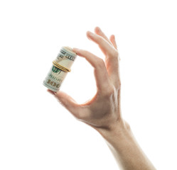 Wall Mural - Hundred dollar bills in a roll in male hand isolated over white background