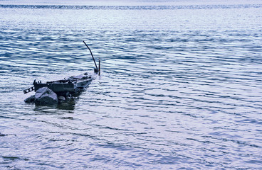 summer landscape on the water old broken boat