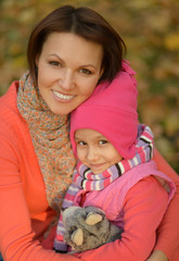 Wall Mural - Portrait of mother with daughter in autumn park